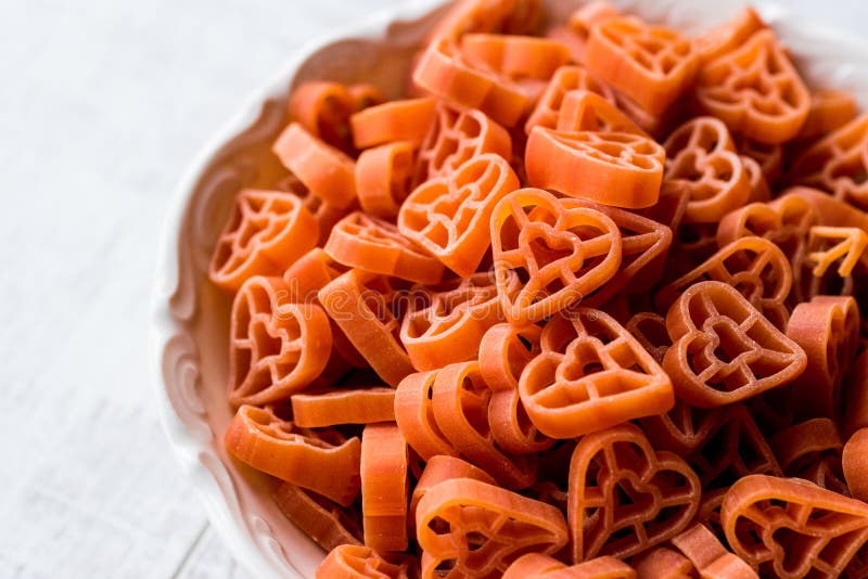 Heart Shaped Raw Spaghetti in ceramic bowl. stock images