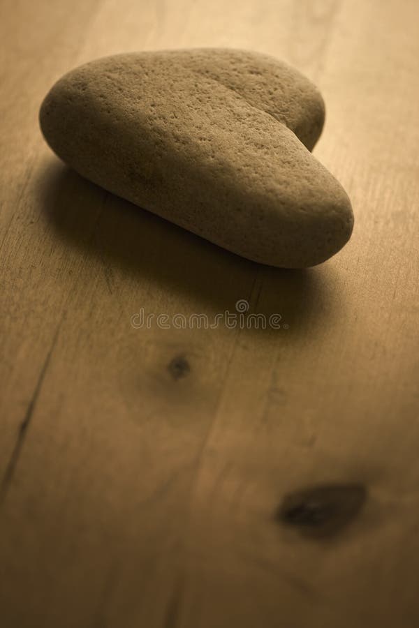 Heart shaped Stone on the Table. Retro style warm light and soft focus view. Heart shaped Stone on the Table. Retro style warm light and soft focus view.