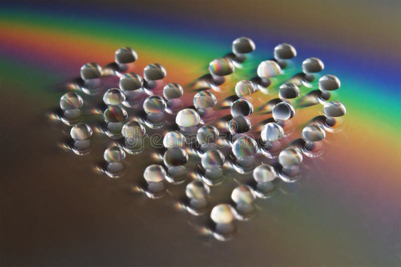 Heart shaped water drops with rainbow ray