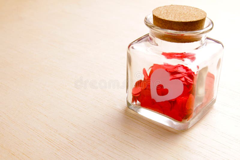 Hearts in a Glass Jar on Wooden Surface Series 2 Stock Photo Image