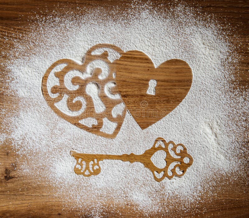 Hearts and a key of the flour as a symbol of love on wooden background. Valentines day background. Vintage retro card.