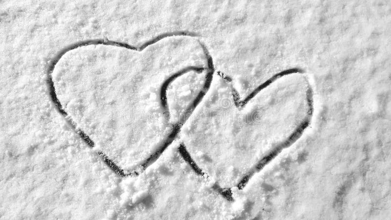 Hearts on snow hand drawing symbol romantic wintertime ice cold surface