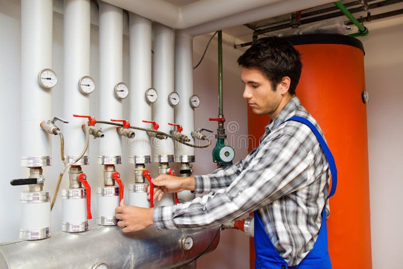 Heating engineer in a boiler room for heating royalty free stock photo Heating engineer in a boiler room for heating royalty free stock photo