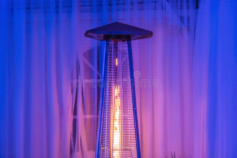 Heating Lamp Heater Placed among the Tables of an Open Cafe Stock Photo