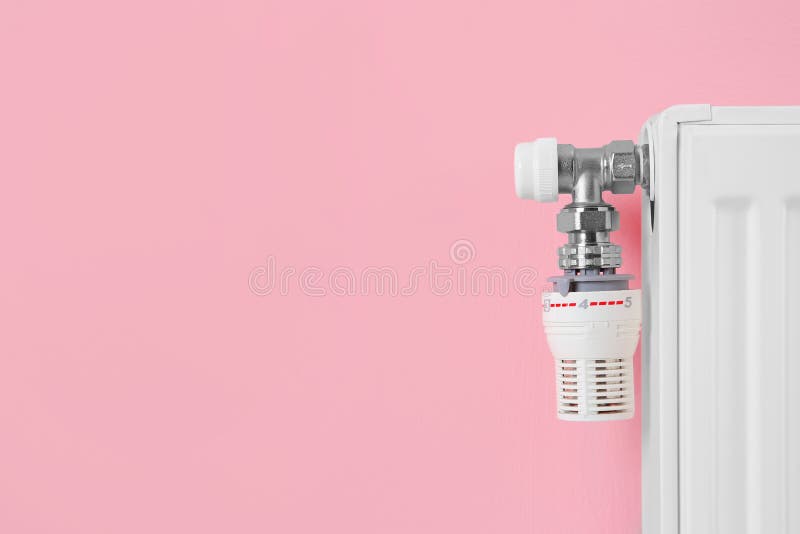 Heating Radiator with Thermostat Near Color Wall. Stock Photo Image