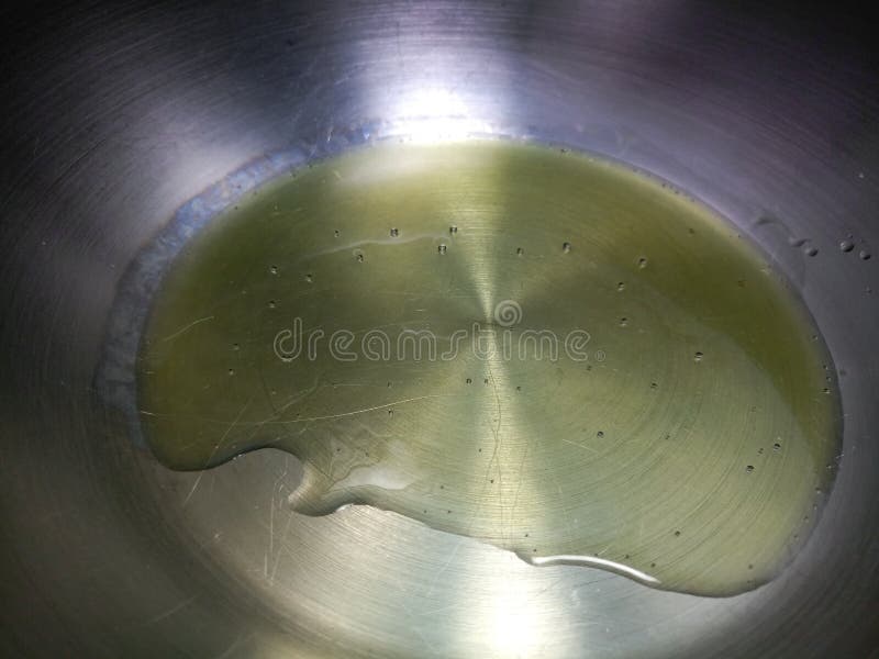 Thick olive oil in a pan stock photo. Image of heating 106363344