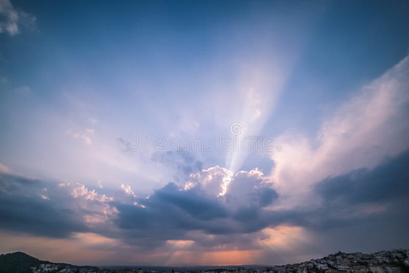 Heavenly Light Rays Piercing Through the Clouds over the Greek Sea stock photo
