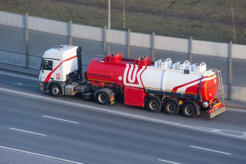 Heavy big fuel tanker truck Luckoil company on city highway. Russia, Saint-Petersburg. 16 april 2020