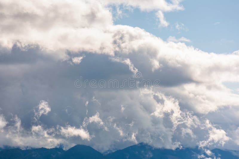 Heavy clouds on a blue sky above mountains september royalty free stock image