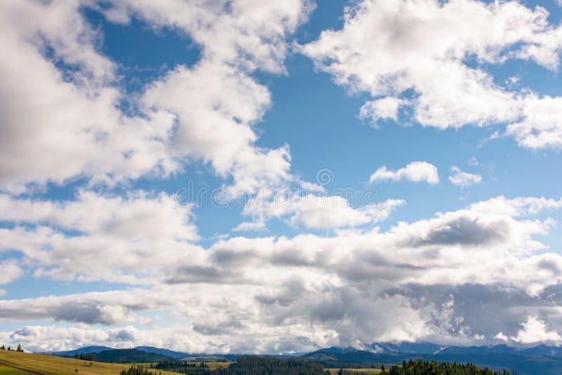 Heavy clouds on a blue sky above mountains september royalty free stock photo