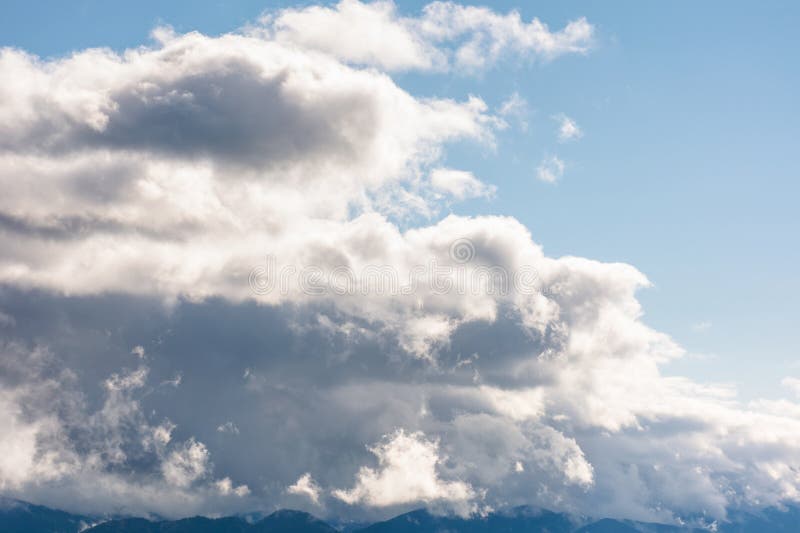Heavy clouds on a blue sky above mountains september stock image