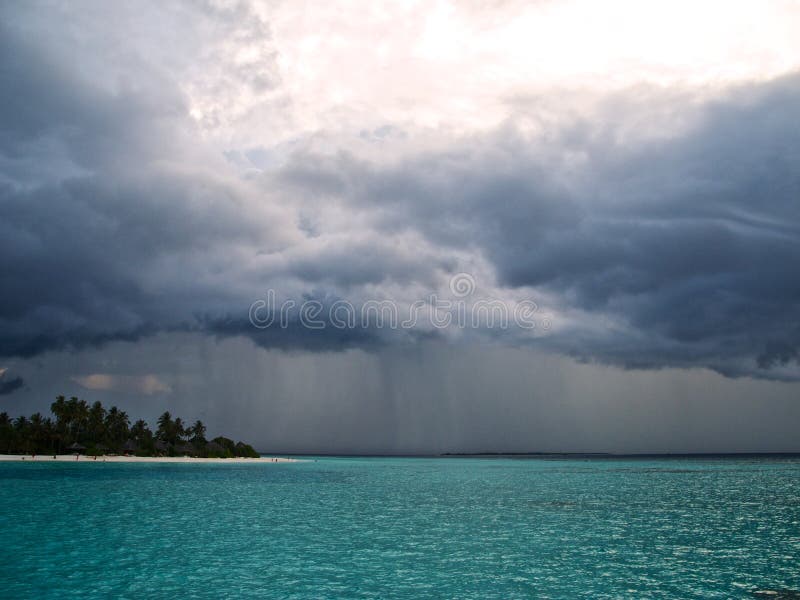 Heavy clouds and rain over the ocean royalty free stock photo
