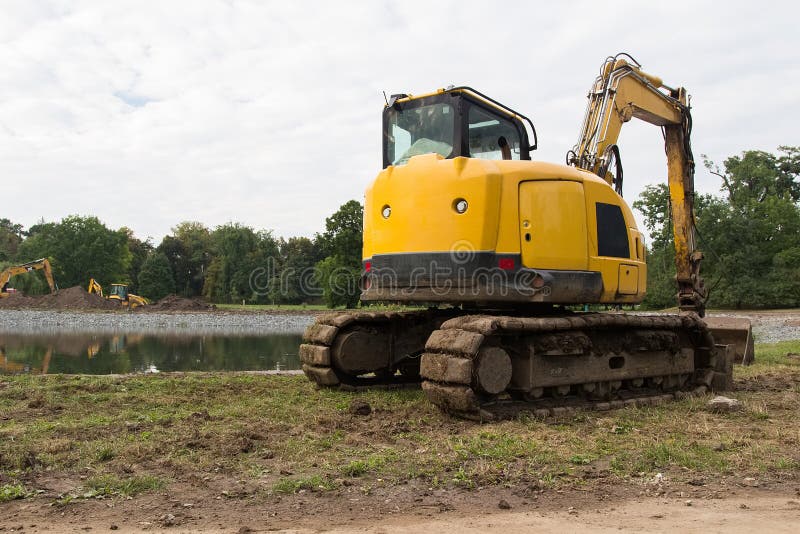 Heavy Construction Equipment. Yellow Excavator on the Construction Site