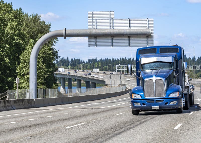 Powerful classic blue and silver big rig semi truck tractor with truck  driver rest compartment and lot of chrome and aluminum accessories driving  on t Stock Photo - Alamy