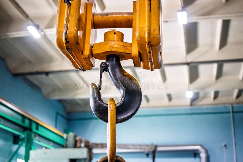 Heavy-duty lifting device showcasing a hook used in an industrial workshop for moving large loads during operational activities royalty free stock photography