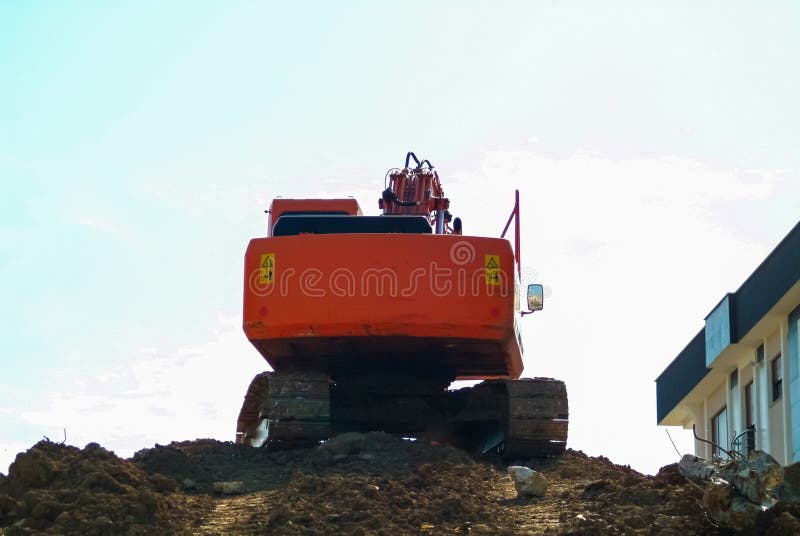 Heavy earth mover, excavator loader machine during earthmoving works outdoors at construction site