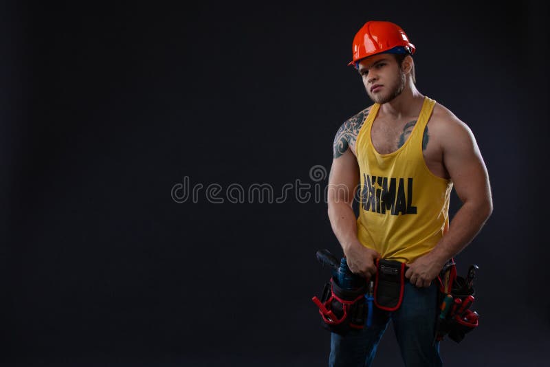 Heavy industry and labour concept - man with confident face expression. Muscle professional builder, repairman in protective royalty free stock images Heavy industry and labour concept - man with confident face expression. Muscle professional builder, repairman in protective royalty free stock images