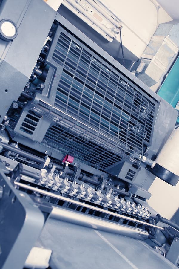 Heavy multicolour offset machine in typography stock photos
