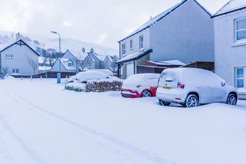 Heavy Snow from Storm Emma. Largs, Scotland, UK - March 01, 2018: Heavy snow on cars after Storm Emma in Scotland also known as the Beast from the East. Red royalty free stock images Heavy Snow from Storm Emma. Largs, Scotland, UK - March 01, 2018: Heavy snow on cars after Storm Emma in Scotland also known as the Beast from the East. Red royalty free stock images