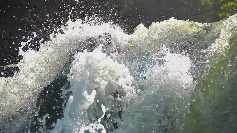 Heavy water torrent running rapidly downhill, splashes closeup