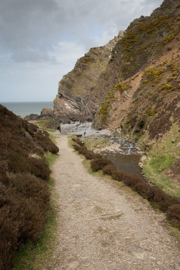 The Heddon Valley in Exmoor National Park Devon leads to the beach at Heddon`s Mouth via a lovely walk alongside the River Heddon. Surrounded by the steep hills of Peter Rock, Highveer and Trentishoe and a short walk to Hunters Inn. Part of the South West Coast Path. The Heddon Valley in Exmoor National Park Devon leads to the beach at Heddon`s Mouth via a lovely walk alongside the River Heddon. Surrounded by the steep hills of Peter Rock, Highveer and Trentishoe and a short walk to Hunters Inn. Part of the South West Coast Path