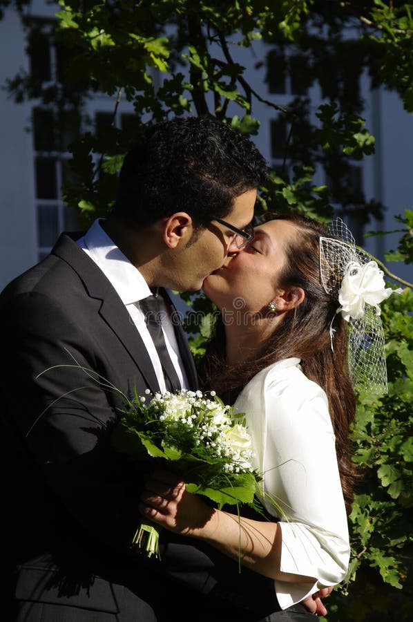 Portrait of a young hispanic wedding couple, bride and groom kissing each other, just married newly weds. Portrait of a young hispanic wedding couple, bride and groom kissing each other, just married newly weds