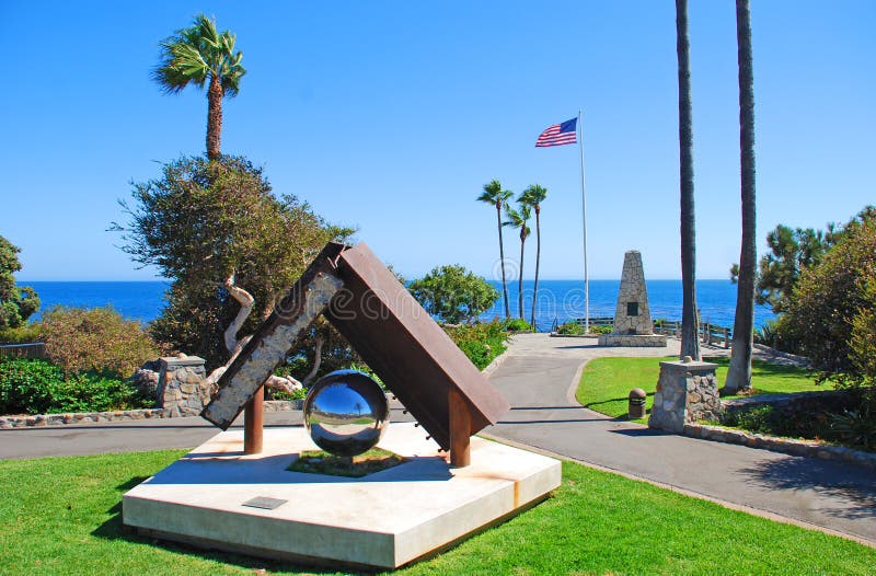 This image shows Heisler Parks Monument Point (in Laguna Beach) along spectacular landscaped walkways with breathtaking views of the Pacific Ocean and rocky coves that line the coastline. The monument seen in the background was dedicated in 1959 to veterans and those who sacrificed their lives to keep us free. The monument seen in the foreground is a part of the Twin Towers and is dedicated to those who lost their lives on 9/11. This image shows Heisler Parks Monument Point (in Laguna Beach) along spectacular landscaped walkways with breathtaking views of the Pacific Ocean and rocky coves that line the coastline. The monument seen in the background was dedicated in 1959 to veterans and those who sacrificed their lives to keep us free. The monument seen in the foreground is a part of the Twin Towers and is dedicated to those who lost their lives on 9/11.