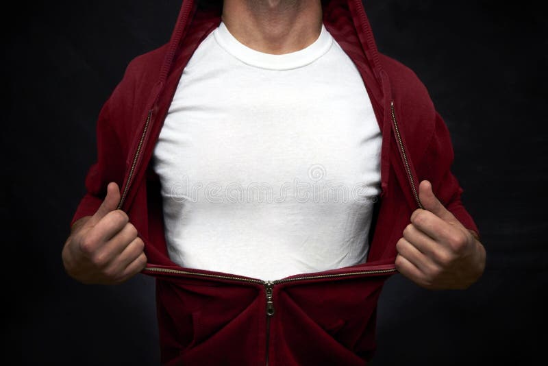 Hero pulling open blue blouse showing white t-shirt on blackboard background. Hero pulling open blue blouse showing white t-shirt on blackboard background