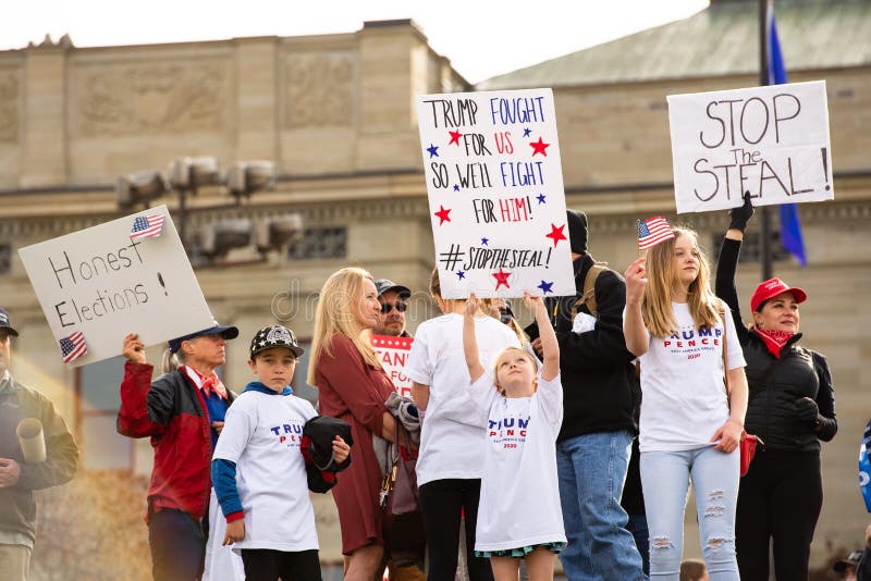 Helena, Montana / Nov 7, 2020: Protesters at `Stop the Steal` rally holding signs for honest election and in support of Donald Trump, little girl hold #stopthesteal poster at Capitol, vote count fraud. Helena, Montana / Nov 7, 2020: Protesters at `Stop the Steal` rally holding signs for honest election and in support of Donald Trump, little girl hold #stopthesteal poster at Capitol, vote count fraud