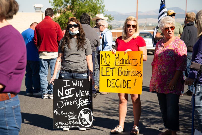 Helena, Montana / September 11, 2020: Protesters hold signs at mask protest, protesting mask mandate, women protest the governors