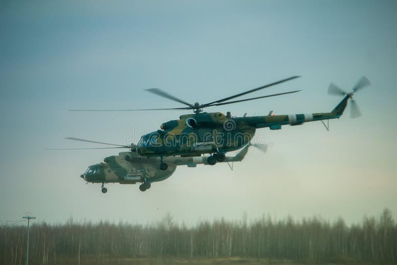 Helicopter in flight at sunset above war field stock photo Helicopter in flight at sunset above war field stock photo