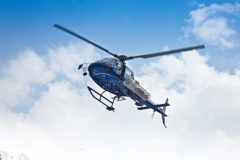 Helicopter flying on clouds