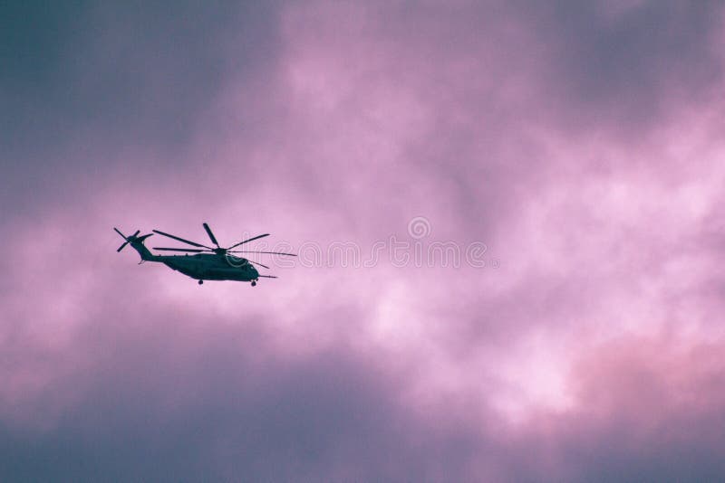 Helicopter Flying in the Purple Cloudy Sky Stock Photo Image of