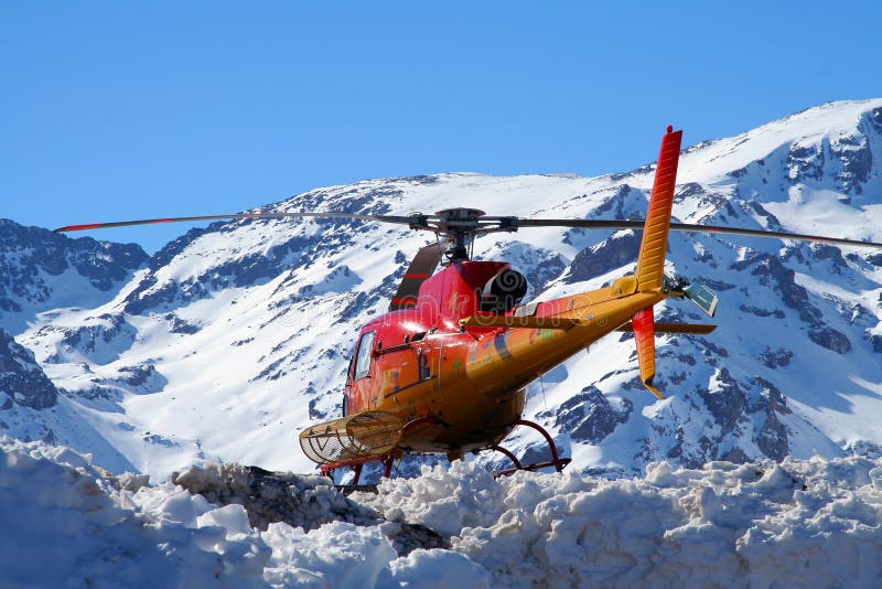 Rescue helicopter flying over snow covered mountain, Santiago, Chile. Rescue helicopter flying over snow covered mountain, Santiago, Chile