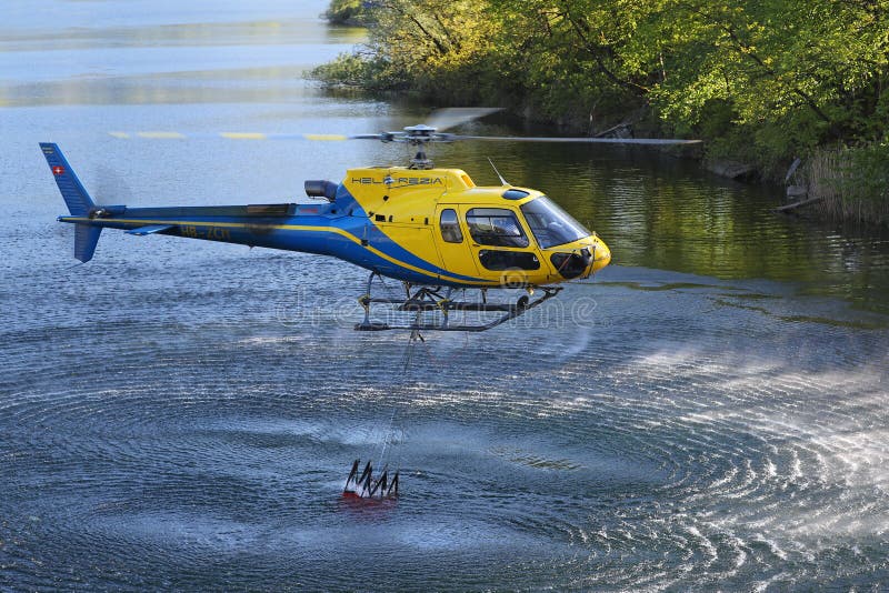 Helicopter picking up water during fire fighting operations