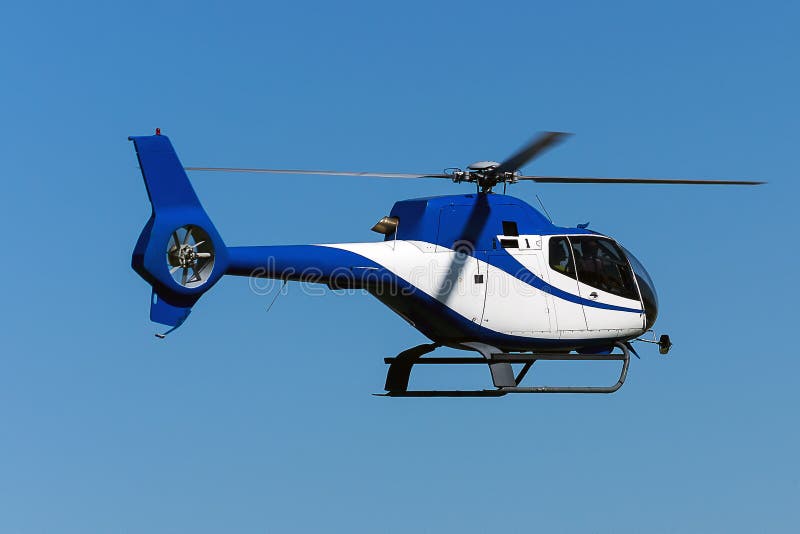 A blue painted helicopter flying in the air. A blue painted helicopter flying in the air.
