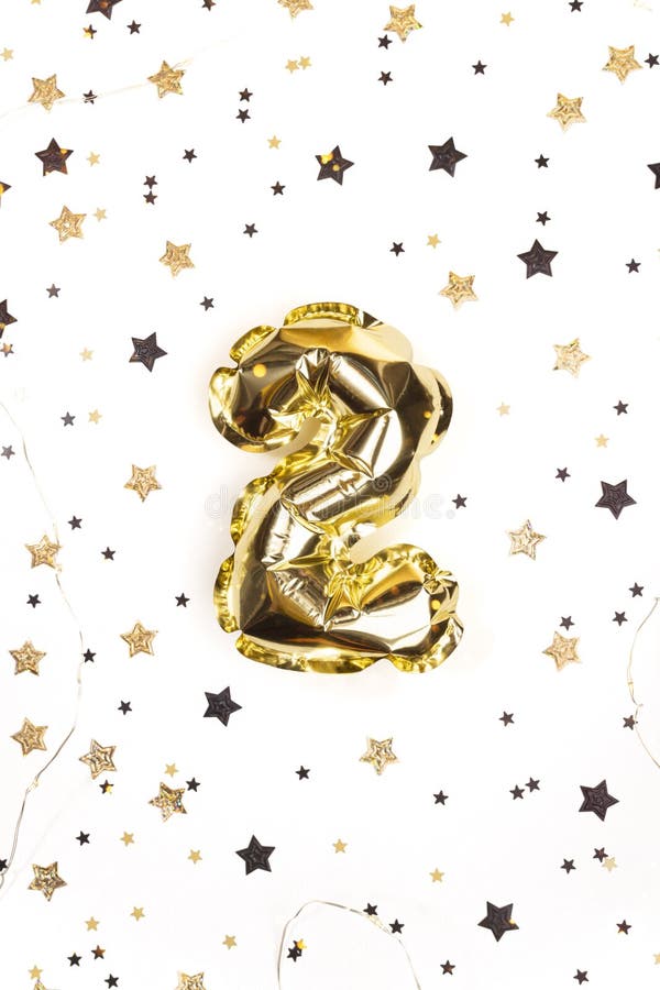 Helium golden balloon number 2. Glowing festive garland with stars confetti. Birthday greeting card. Two-year anniversary background. Helium golden balloon number 2. Glowing festive garland with stars confetti. Birthday greeting card. Two-year anniversary background