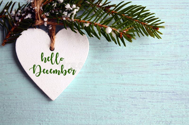 Hello december Decoratieve witte houten Kerstmishart en sparrentak op blauwe houten achtergrond royalty-vrije stock afbeelding Hello december Decoratieve witte houten Kerstmishart en sparrentak op blauwe houten achtergrond royalty-vrije stock afbeelding