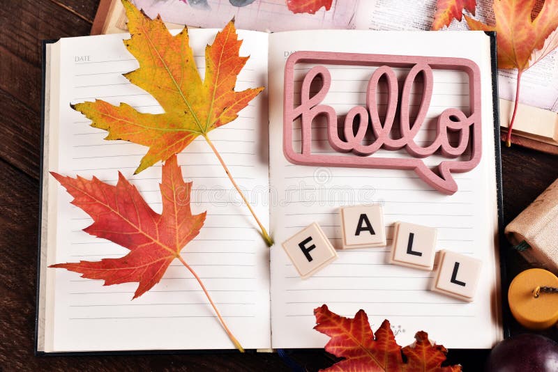 Hello Fall background with a diary notebook and colorful leaves royalty free stock photo