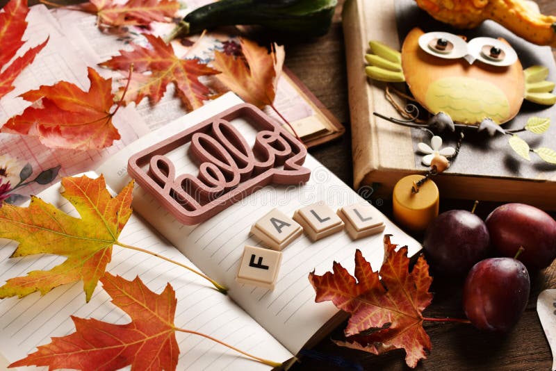 Hello Fall background with a diary notebook and colorful leaves royalty free stock photos