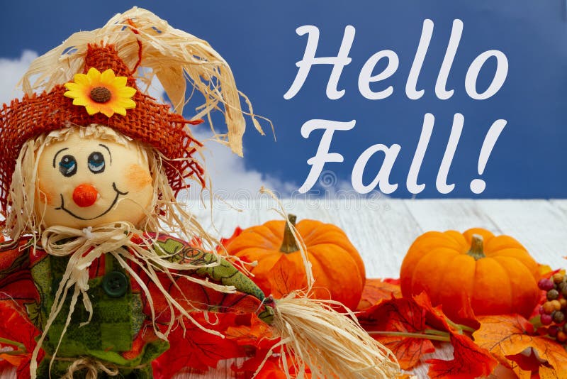 Hello Fall greeting with fall leaves, scarecrow, and pumpkins with sky royalty free stock photos