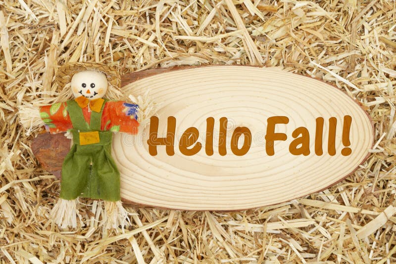 Hello Fall message with scarecrow and straw hay royalty free stock photo