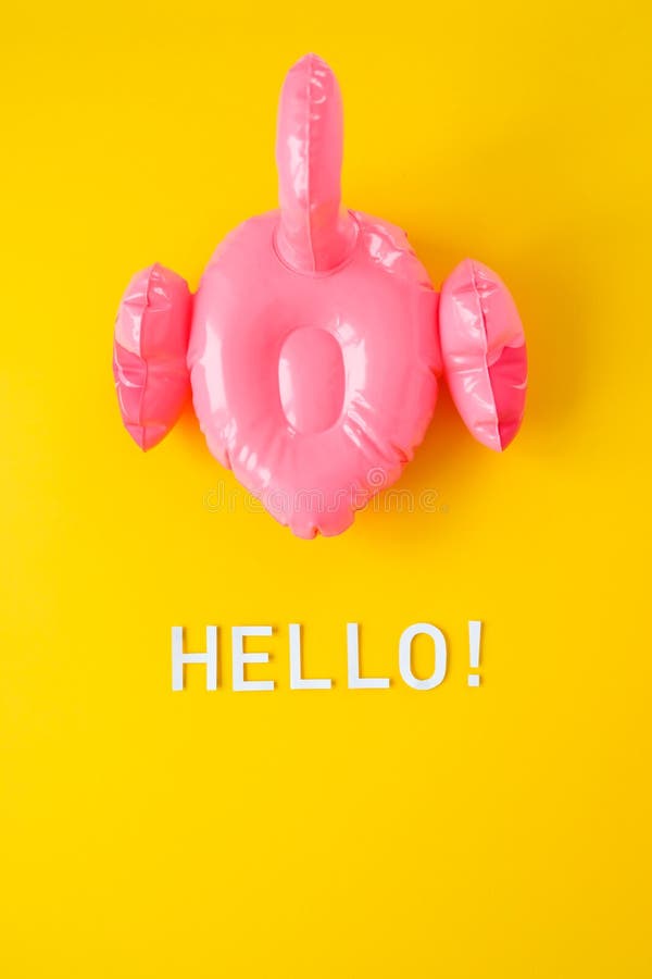 Inflatable pink flamingos on an yellow background stock image