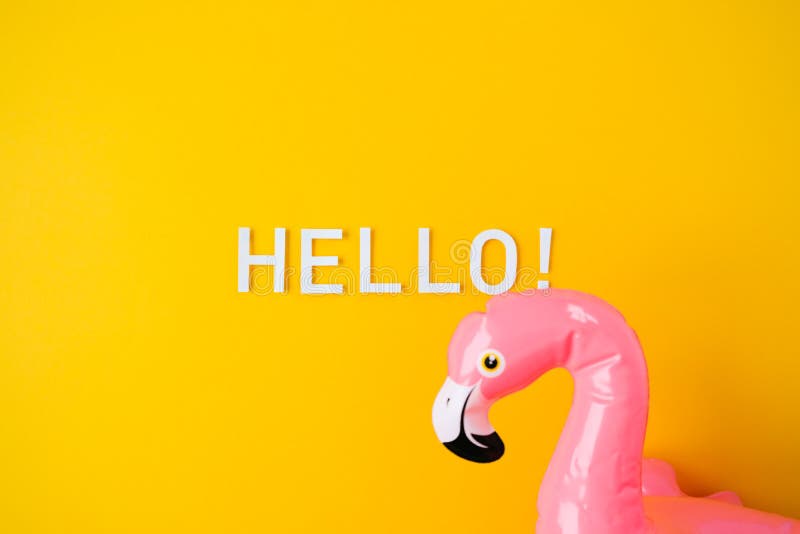 Inflatable pink flamingos on an yellow background royalty free stock photo