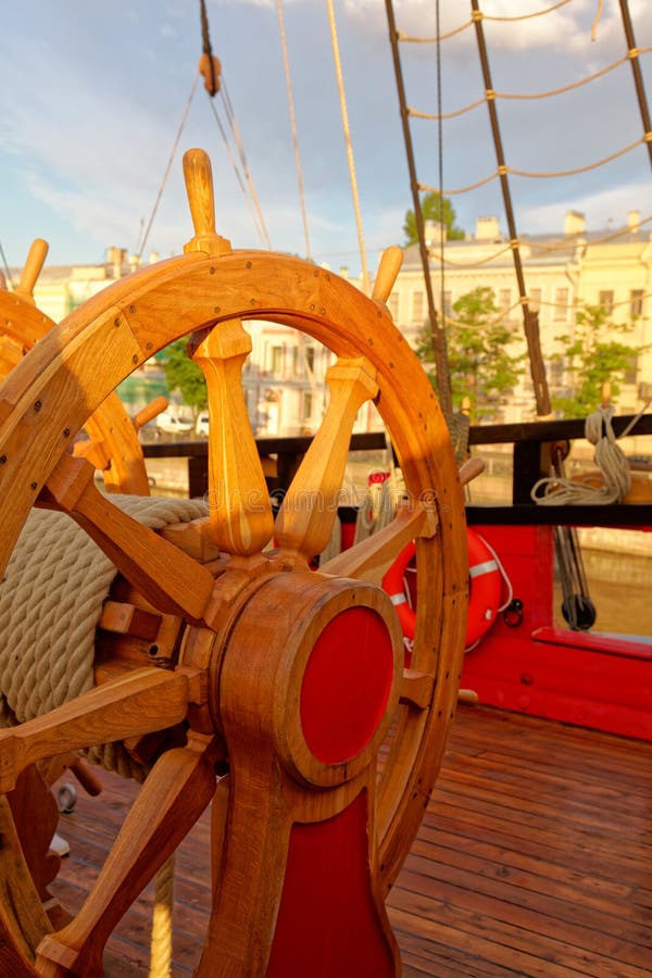 Helm wheel of an old wooden sailboat. Details of the deck of the ship stock images Helm wheel of an old wooden sailboat. Details of the deck of the ship stock images