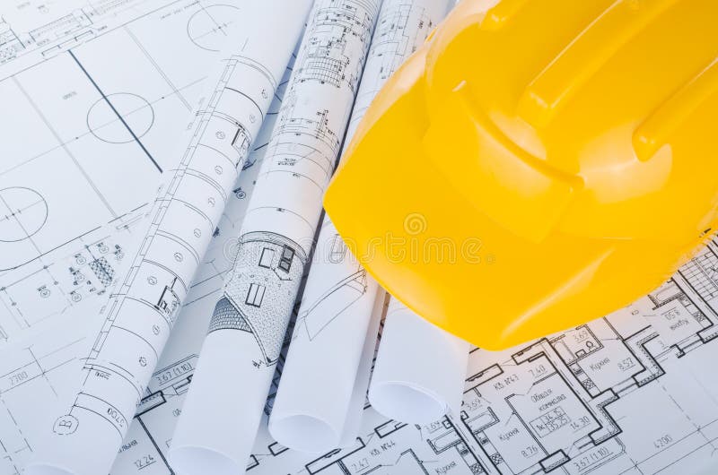 Helmet on the construction drawings isolated royalty free stock image