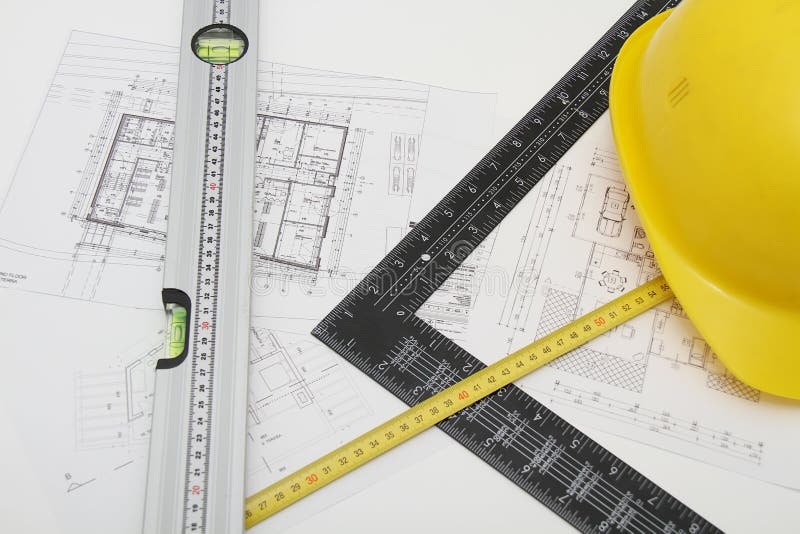 Helmet and tools for construction drawings and buildings stock images