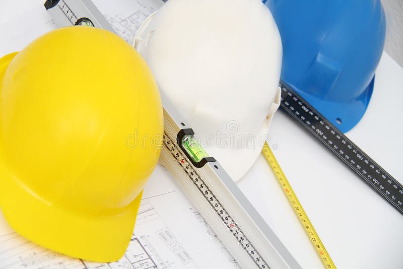 Helmets and tools for construction drawings and buildings stock image
