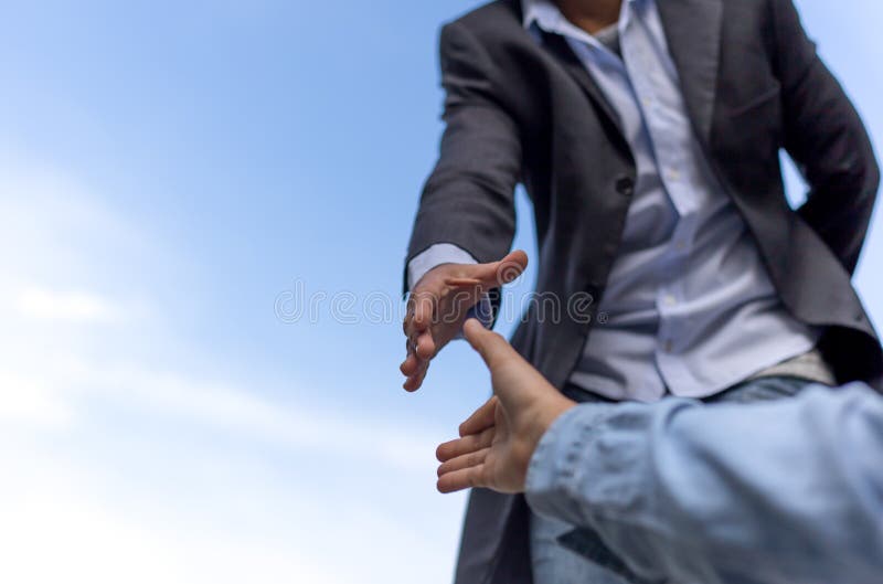 Help concept hand reaching out to help someone with blue sky stock image Help concept hand reaching out to help someone with blue sky stock image