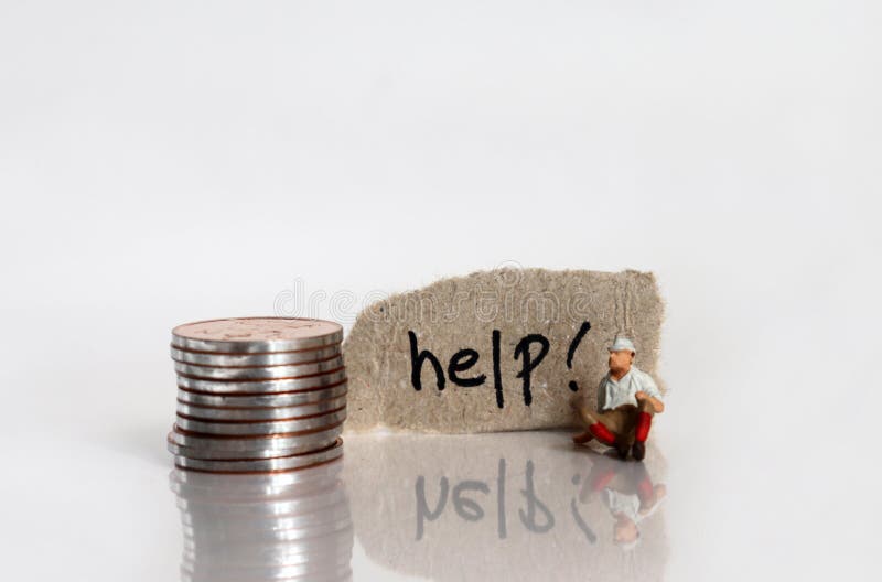 The `help! ` text written on a torn cardboard. A stack of coins and a miniature man sitting. royalty free stock photo
